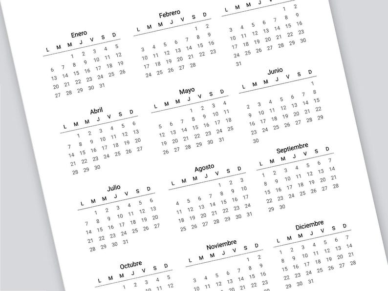 May include: A black and white calendar with the months of the year in Spanish. The calendar is printed on white paper and has a simple design.
