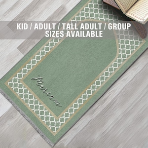 May include: A green prayer rug with a white and gold geometric pattern. The rug has a large arch in the center and the word "mariam" written in cursive. The text "KID / ADULT / TALL ADULT / GROUP SIZES AVAILABLE" is written at the top of the image.