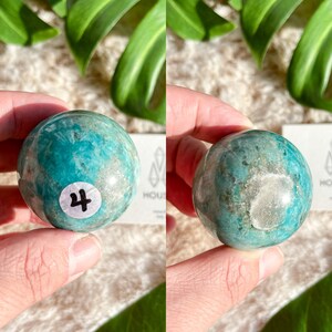 May include: A green and white Amazonite sphere with a white label that says "4" on it.