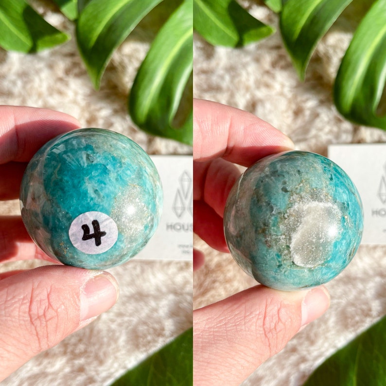 May include: A green and white Amazonite sphere with a white label that says "4" on it.