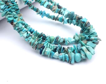 May include: A strand of turquoise chip beads, featuring a mix of light and dark blue hues. The beads are irregular in shape and size, creating a unique and natural look.