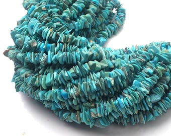 May include: A strand of turquoise chip beads, featuring a mix of light and dark blue hues. The chips are irregularly shaped and have a natural, rough texture.