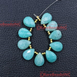 May include: A strand of ten faceted, pear-shaped teal amazonite beads arranged in a circular pattern, interspersed with small, round, metallic gold-colored spacer beads on a thin silver-toned wire, featuring the text RareBeadsINC in red.