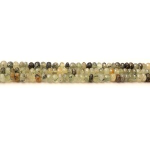 May include: A strand of green, brown, and black gemstone beads. The beads are round and have a faceted finish.