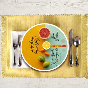 May include: A plate divided into four sections, each representing a food group: non-starchy vegetables, fiber-rich carbohydrates, lean protein, and a quarter of the plate. The plate is decorated with a variety of fruits and vegetables, including a grapefruit, a lime, a lemon, and a few small orange peppers.