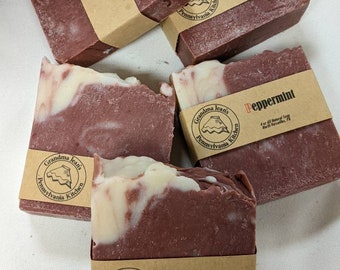 May include: Four bars of handmade peppermint soap with a swirl design. Each bar is wrapped in brown paper with a label that reads "Grandma Jean's Pennsylvania Kitchen" and "Peppermint 4 oz All Natural Soap North Versailles, PA".