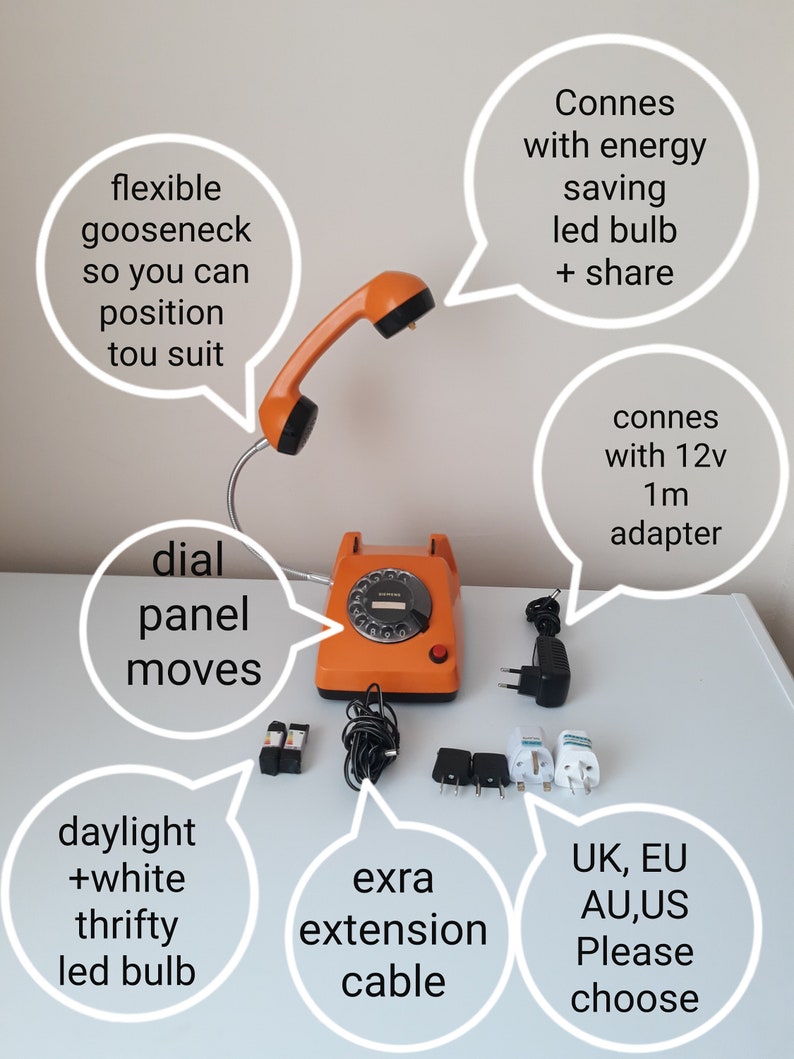 May include: An orange vintage rotary dial desk phone with a flexible gooseneck and a handset. The phone includes an extra extension cable, a daylight LED bulb, and various adapter plugs. The text on the image says "UK, EU, AU, US Please choose."