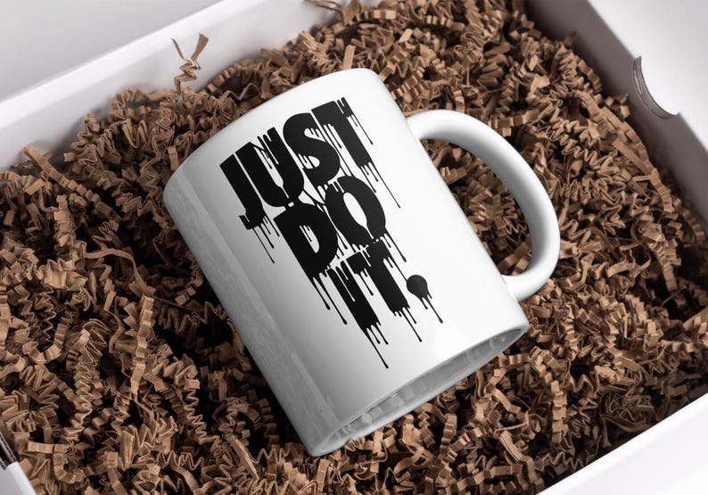May include: White ceramic mug with a black "JUST DO IT." graphic with dripping paint effect.