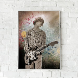 May include: A black and white photograph of a musician playing a guitar. The musician is wearing a patterned shirt and is standing in front of a colourful background with paint splatters.