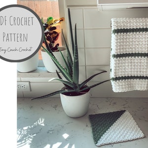 May include: A white and green crochet kitchen set, including a towel and a square pot holder. The towel hangs on a metal bar, and the pot holder is on the counter. The image also features a potted aloe vera plant and a sign that says "PDF Crochet Pattern Tiny Couch Crochet."