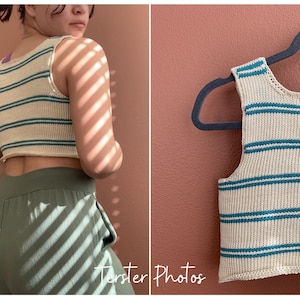 May include: Cream-colored, striped crop top with teal horizontal stripes. The sleeveless top is made of a knitted material and is shown on a person and on a hanger. The top is paired with green pants.