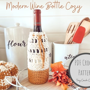 May include: A crocheted wine bottle cozy in white and mustard yellow with a PDF crochet pattern download available. The cozy is on a wine bottle with a white background.