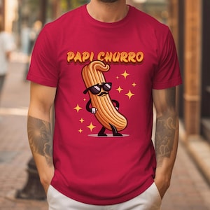 May include: Red t-shirt with a cartoon churro wearing sunglasses and the text "Papi Churro".