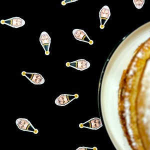 May include: A black background scattered with small stickers featuring a man's face wearing a party hat with the word "retired" on it. A partially visible plate of cake is in the right corner.