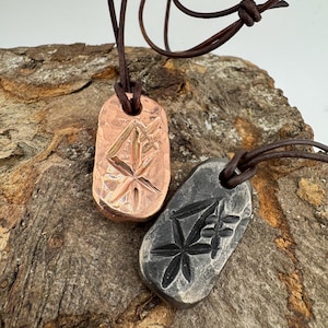 May include: A white ceramic mug with a black handle and the text "But First, Coffee" in a black, handwritten-style font. The mug is on a white surface.