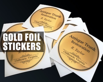 May include: A collection of circular gold foil stickers featuring black text that reads Antique Trunk Restoration, R. Taylor, and Chilhowie, Virginia, with decorative flourishes. Each sticker is set on a square white backing paper.