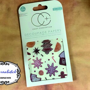 Decoupage paper pack containing 3 sheets of 1 design with a Christmas theme featuring biscuit images of gingerbread men, snowflakes etc.