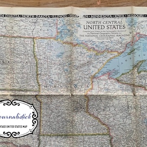 Könnte beinhalten: Eine Vintage-Karte des Nordzentrums der Vereinigten Staaten, die die Bundesstaaten North Dakota, South Dakota, Minnesota, Wisconsin, Iowa und Michigan zeigt. Die Karte trägt den Titel "North Central United States" und wurde von der Kartographischen Abteilung der National Geographic Society für The National Geographic Magazine zusammengestellt und gezeichnet.