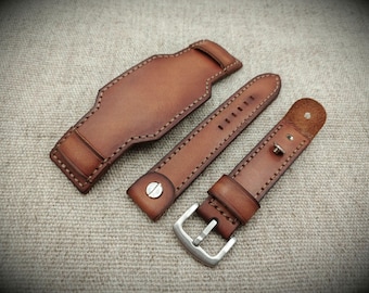May include: Three brown leather watch straps with stitching. The straps are different lengths and widths. The straps have silver buckles.