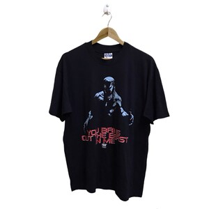 May include: Black t-shirt with a graphic of a creature with red eyes and the text "You bring out the beast in me".