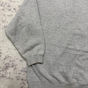 May include: A heather gray sweatshirt with ribbed cuffs and hem. The long sleeves and crew neck design offer a classic, casual look. The fabric appears to be a soft, medium-weight material, suitable for cooler weather.