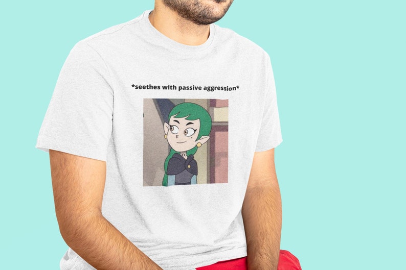 May include: White t-shirt with a cartoon image of a green-haired woman with the text "*seething with passive aggression*" printed on the front.
