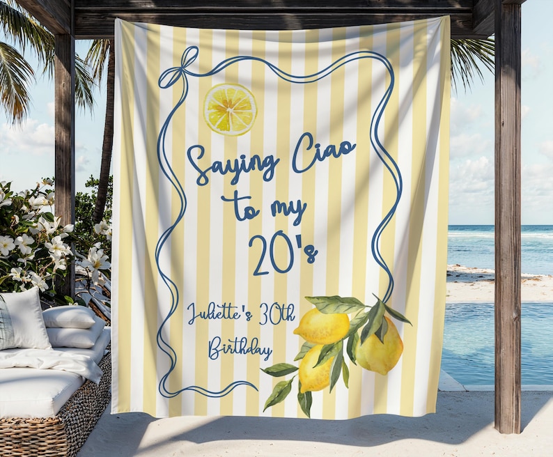 May include: A yellow and white striped beach towel with a blue border and the text "Saying Ciao to my 20's". The towel features a lemon slice and lemon branch illustration, perfect for a 30th birthday celebration.
