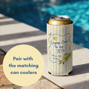 May include: A yellow and white striped can cooler with the text "Saying Ciao to my 20's" and a lemon illustration. The cooler is designed to keep beverages cold. The background shows a pool.