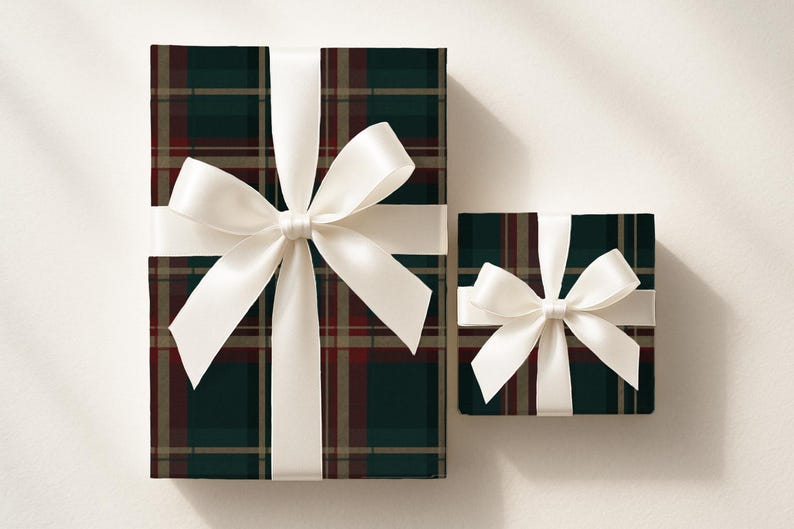 May include: Two wrapped gifts with white satin bows. The wrapping paper has a plaid pattern in dark green, burgundy, and tan. The gifts are on a light background.