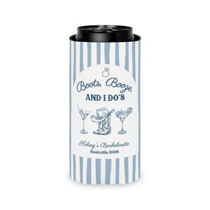 May include: A blue and white striped can cooler with the text "Boots, Booze, AND I DO'S" and illustrations of a martini, cowboy boot, and margarita. The text "Kelsey's Bachelorette Nashville 2026" is also displayed.