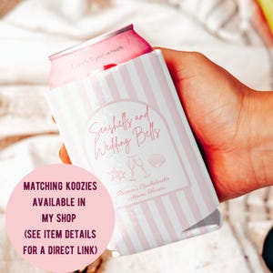 May include: A pink and white striped koozie with the text "Seashells and Wedding Bells" and "Bianca's Bachelorette Miami, Florida". The koozie has a seashell and champagne glass graphic. A pink can is inside the koozie.