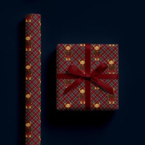 May include: Red and green plaid wrapping paper and a wrapped gift box with a burgundy ribbon. The paper and box feature a repeating pattern of teddy bears wearing outfits. The background is a dark blue.