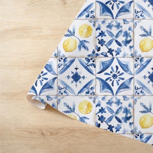 May include: Blue and white patterned wrapping paper with yellow lemons. The pattern resembles traditional Portuguese tiles.