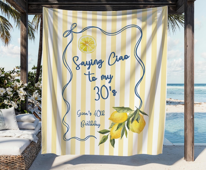 May include: A yellow and white striped beach towel with the text "Saying Ciao to my 30's" and "Gina's 40th Birthday". The towel features a lemon slice and a lemon branch with green leaves.