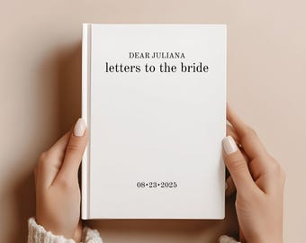 May include: White book with the text "Dear Juliana letters to the bride" and the date "08-23-2025" on the cover.