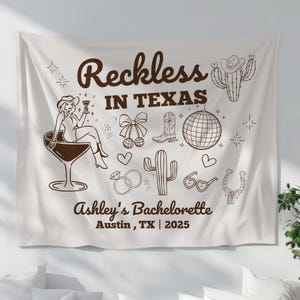 May include: White tapestry with brown text and illustrations. The text reads "Reckless in Texas" and "Ashley's Bachelorette Austin, TX | 2025". The illustrations include a woman in a cowboy hat holding a drink, a cactus, a horseshoe, a disco ball, and a cowboy boot.