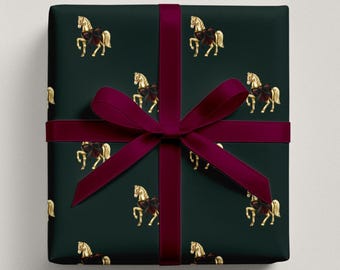 May include: Gift wrap featuring a dark green background with a repeating pattern of gold carousel horses. A deep burgundy ribbon is tied around the wrapped package in a classic bow. The overall aesthetic is elegant and festive.