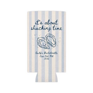 May include: A white and light blue striped can cooler with the text "it's about shucking time" and an illustration of two oysters. Below the illustration is the text "Emily's Bachelorette Cape Cod, MA 2026".