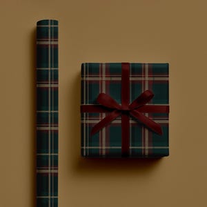May include: A roll of plaid wrapping paper and a wrapped gift box. The wrapping paper and gift box feature a dark green, burgundy, and beige plaid pattern. The gift box is tied with a burgundy ribbon.