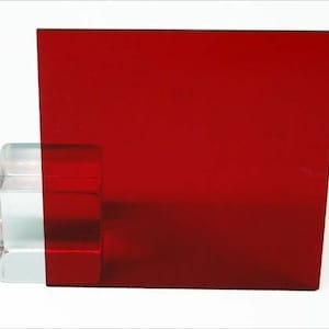May include: A sheet of red acrylic plastic. The plastic is smooth and has a slight sheen.