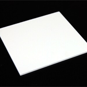 May include: A white square sheet of acrylic plastic.