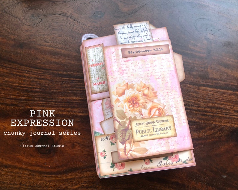 May include: A pink and brown journal with the text "PINK EXPRESSION chunky journal series Citrus Journal Studio" on the front cover. The journal has a floral design with a rose and a label that reads "GREAT GRAND WINDSOR PUBLIC LIBRARY 41, Old Martin St. London". The journal is open to a page with the date "September 1916" written on it.