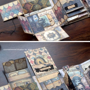 May include: A multi-layered paper craft book with a dark, gothic theme. The book is decorated with various textures, patterns, and images, including a skull, a moon, and a witch. The book is open to reveal several pockets and compartments, each with a different design and label. The labels include "Potent", "Moonray", "Moonfire", and "Mystical".