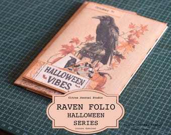 May include: A digital download for a Halloween themed journal folio with a raven, leaves, and the text "Halloween Vibes". The title of the folio is "Raven Folio Halloween Series".