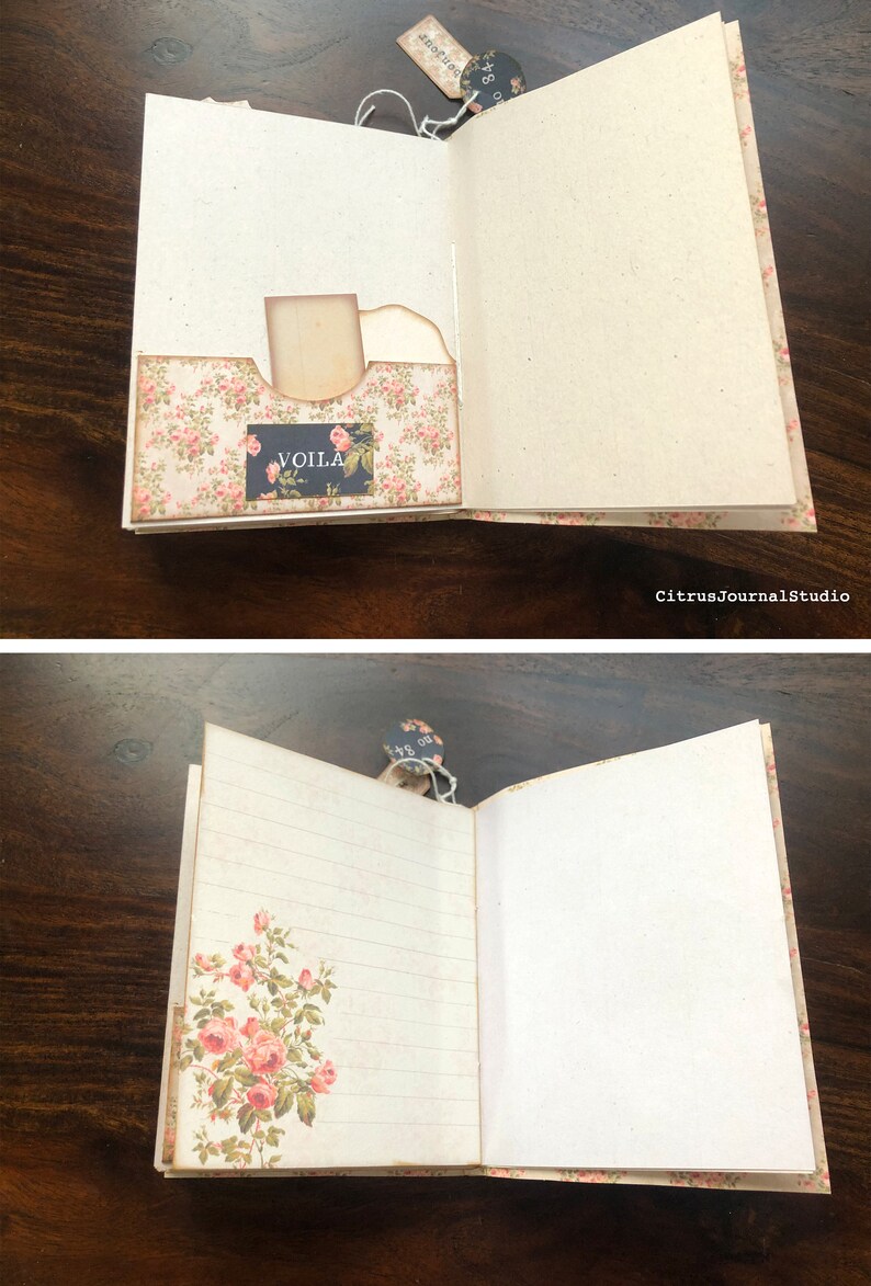 May include: Open vintage journal with a floral design on the cover. The journal has a pocket on the inside cover with a tag that says "VOILA". The pages are lined and blank.