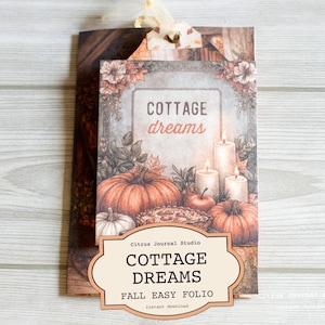 May include: A fall-themed folio with the words "Cottage Dreams" and "Fall Easy Folio." The cover features pumpkins, candles, and an apple pie. The design has a rustic, vintage aesthetic with warm colors and floral accents.