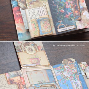May include: A multi-layered scrapbook with floral and patterned paper, featuring a variety of pockets and tabs. The scrapbook is decorated with vintage-style embellishments and includes the text "shabby chic" and "beautiful".