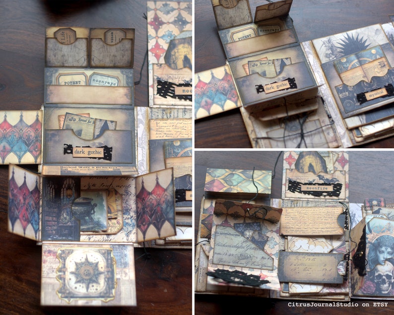 May include: A multi-layered, dark brown and black paper craft box with intricate designs and text. The box is decorated with black lace, and the text includes "dark gothic", "moonfire", and "mystical".
