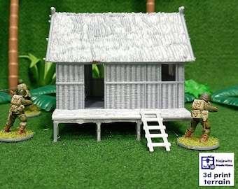 May include: A gray, wooden, thatched-roof hut with a ladder on the front porch. Two miniature figures of soldiers are standing in front of the hut. The hut is surrounded by green grass and palm trees.