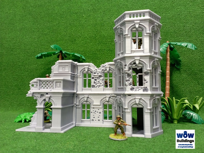 May include: A gray, detailed, multi-sectioned, ruined building model with a tower, windows, and a doorway. The building has a distressed, battle-damaged look with bullet holes and missing sections. The model is set against a green background with palm trees.
